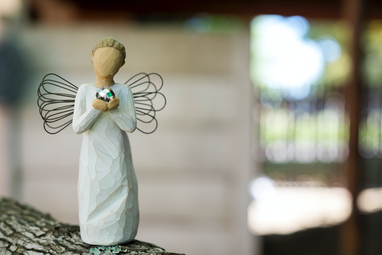 Angel figurine holding a heart figure made of willow tree