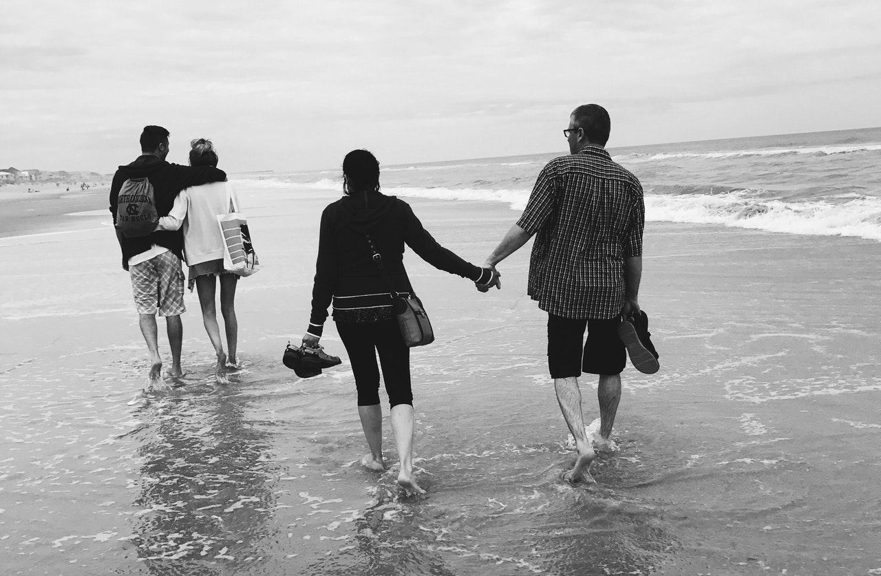 Two Couples Walking In the Beach