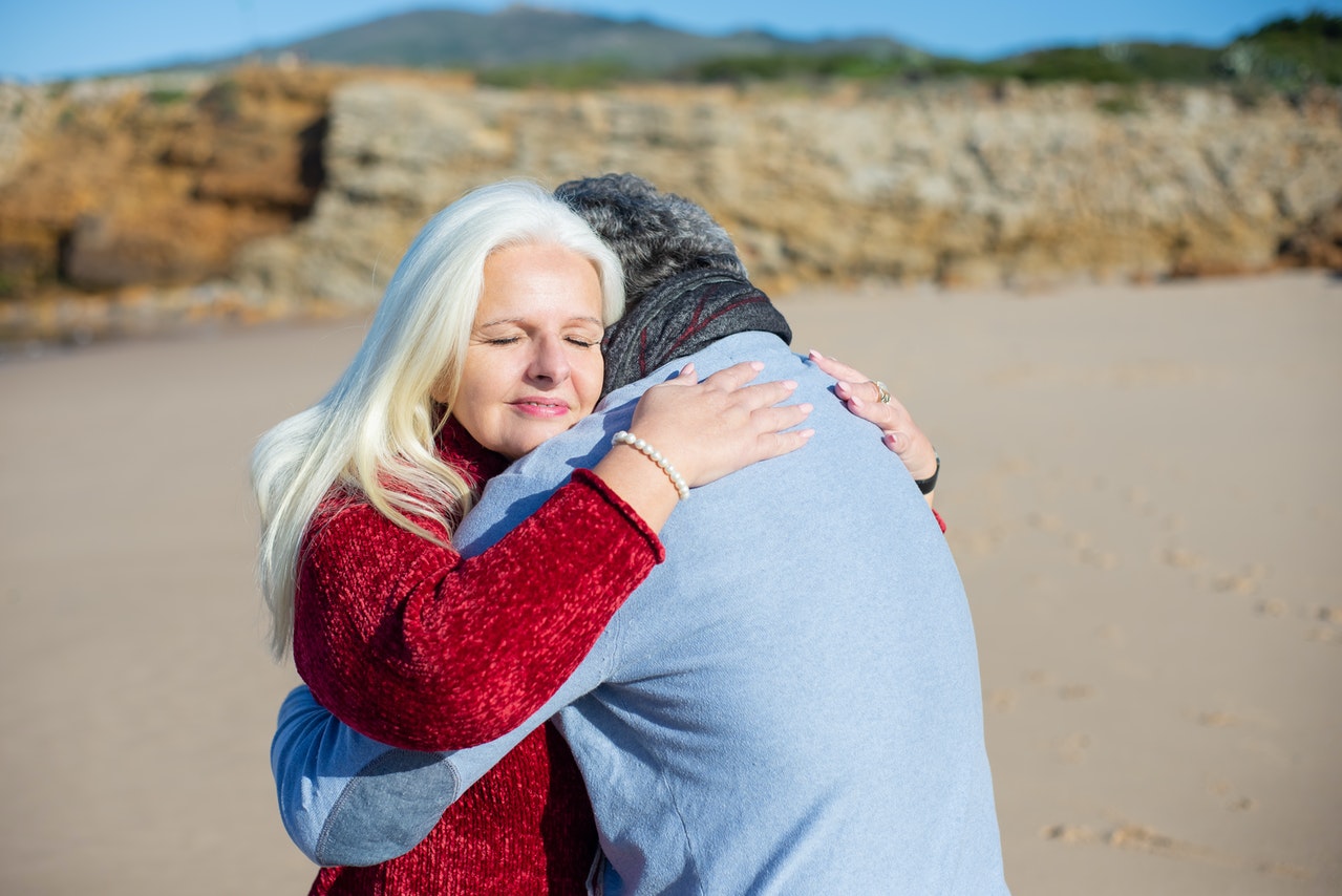 Blond Elderly Woman Hugging a Man
