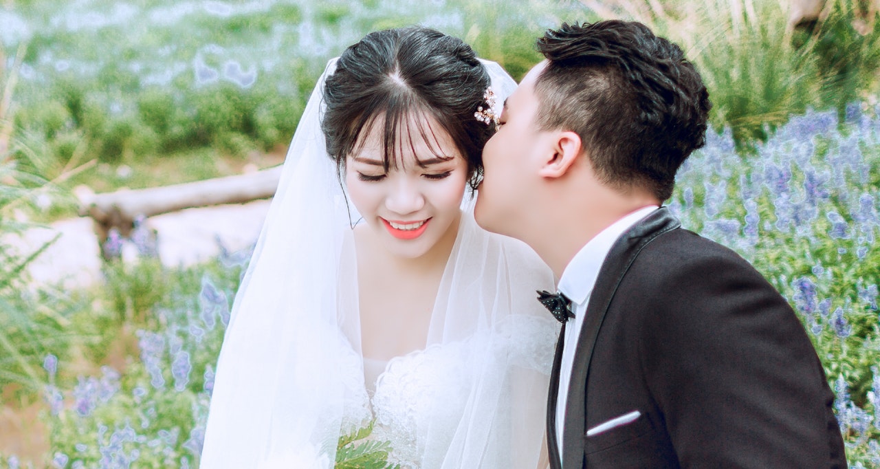 Groom Kissing His Bride on Her Cheek