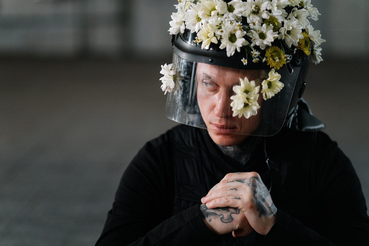 Man Wearing A Flower-Covered Helmet
