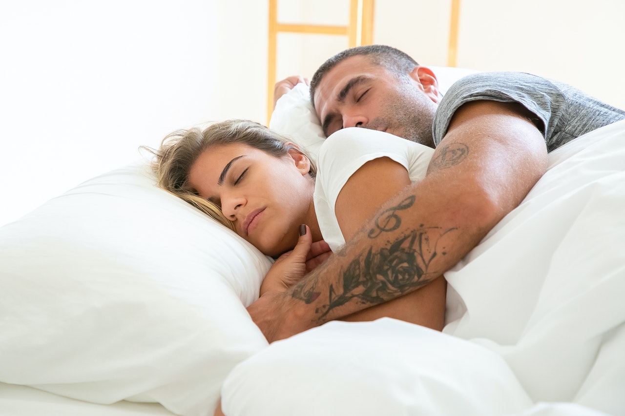 A Man Hugging a Woman While Sleeping