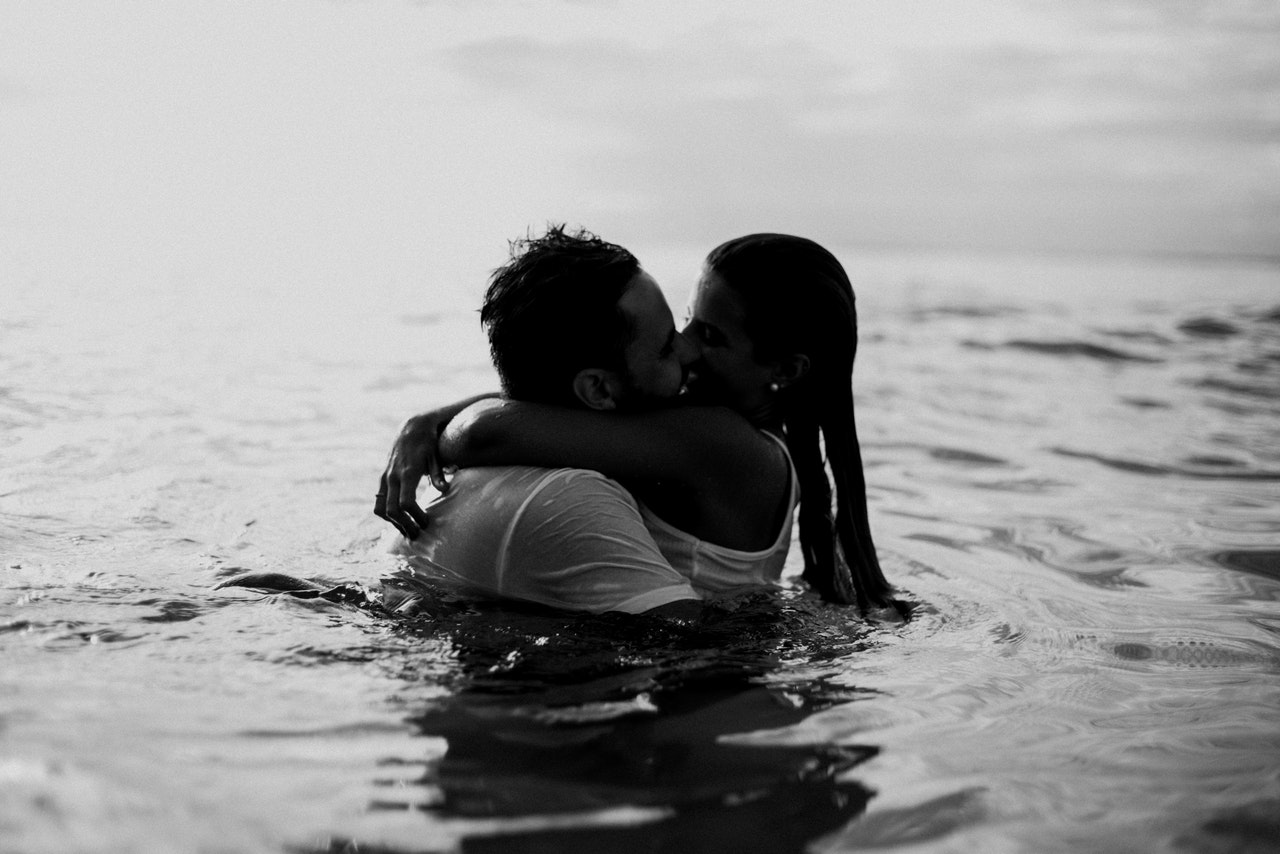 A Man and a Woman Kissing Together In The Beach