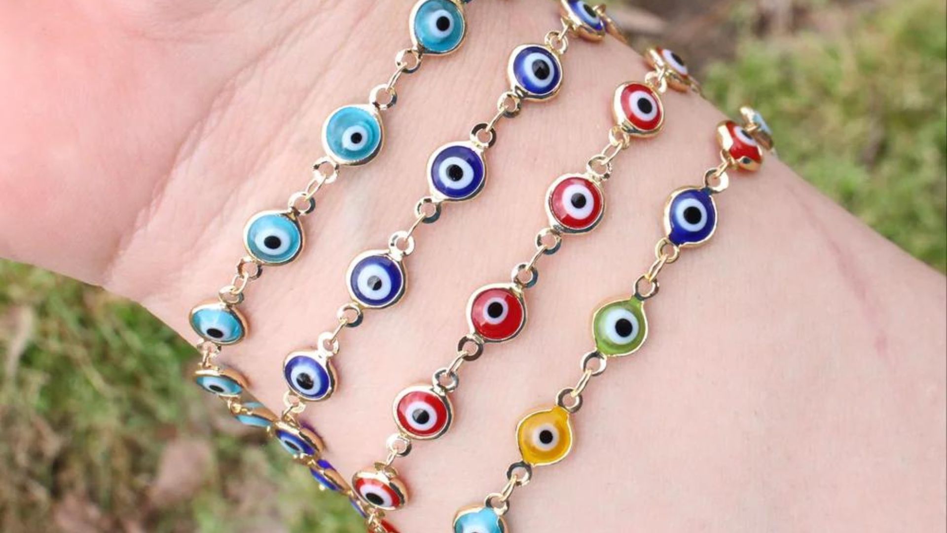 Four Different Colors Of Evil Eye Bracelets On Woman's Wrist