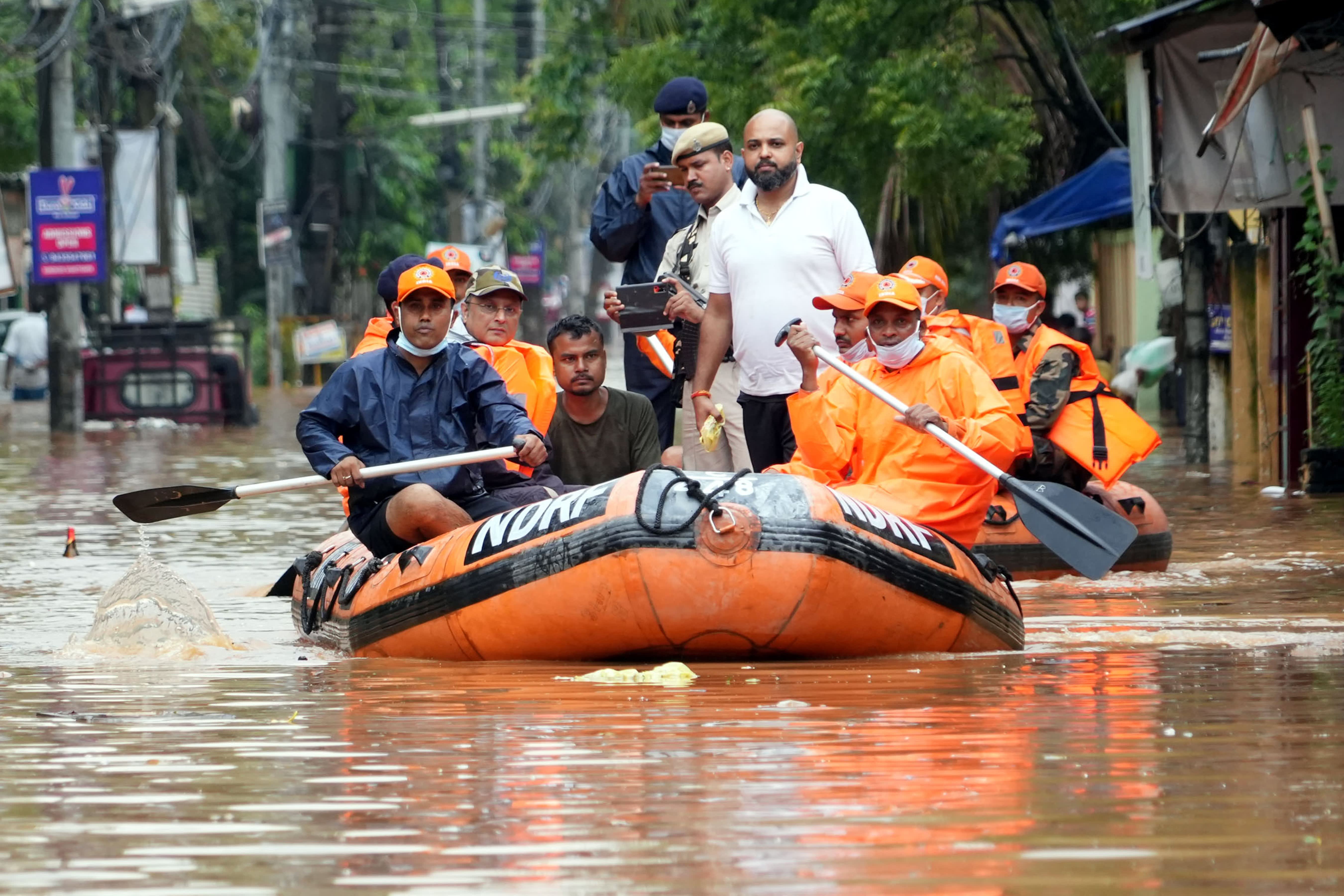 People Evacuating From The Flooded Area From Their Homes