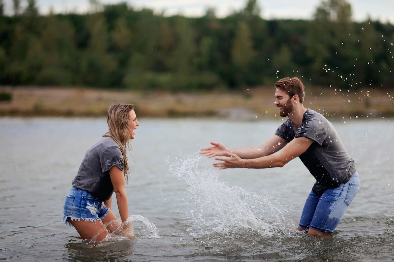 Man and Woman Playing on Water